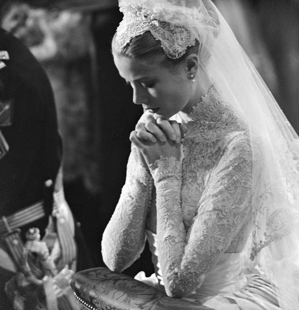 Grace Kelly prays during her wedding to Prince Rainier of Monaco on April 20, 1956.